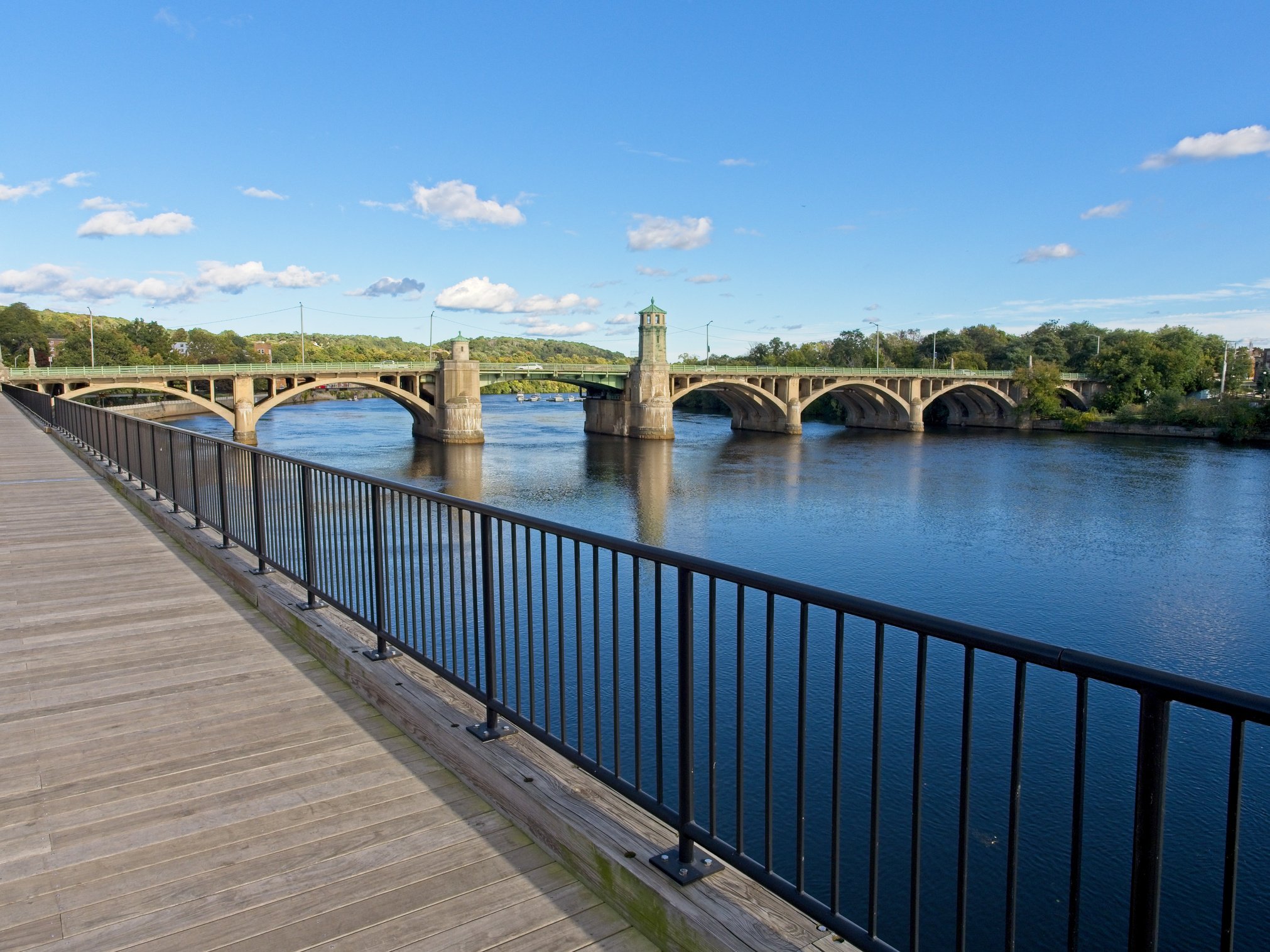 Walkway along the Haverhill side with Basiliere bridge crossing the Merrimack river between Bradford and Haverhill Massachusetts