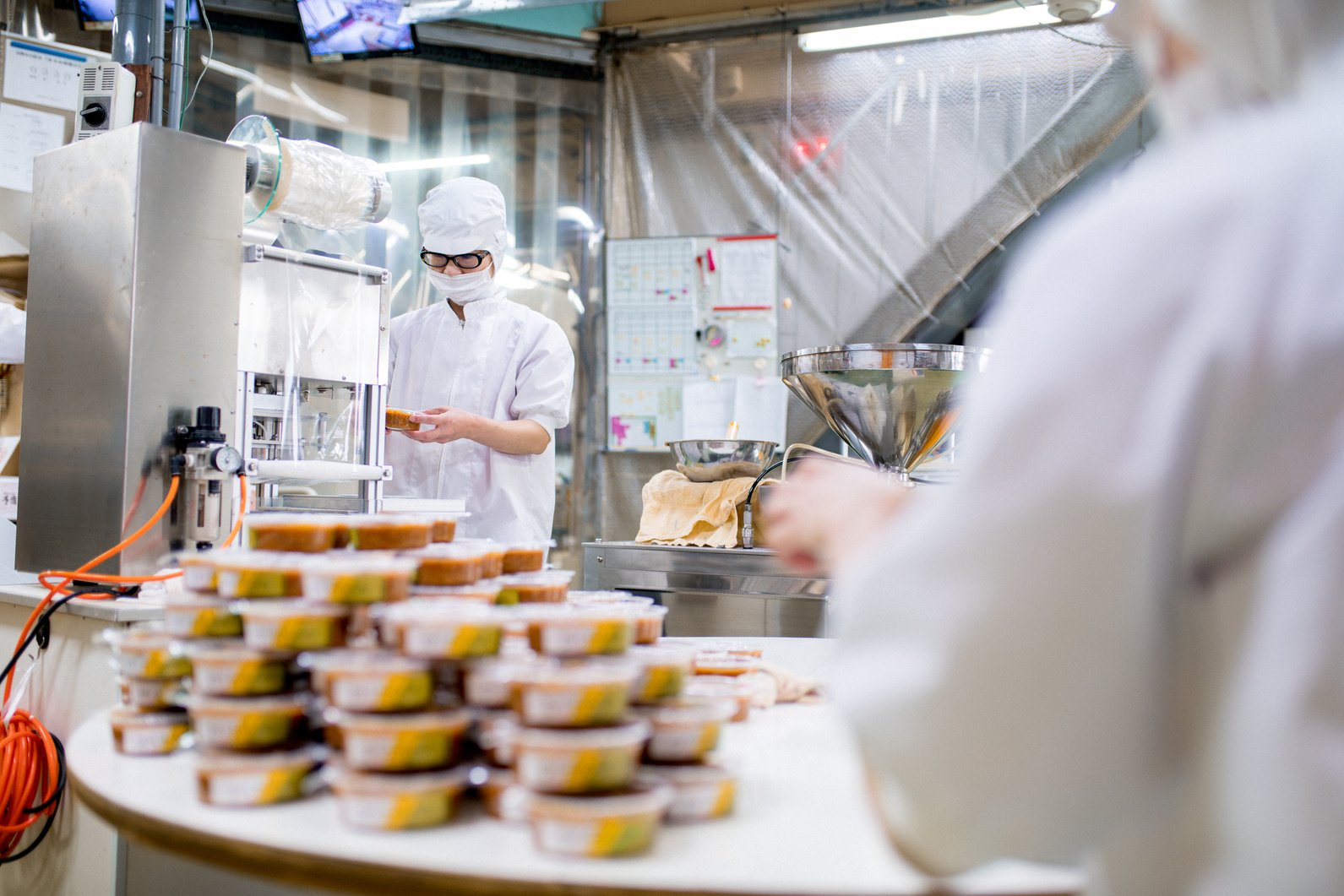 Workers in a food processing factory packaging food